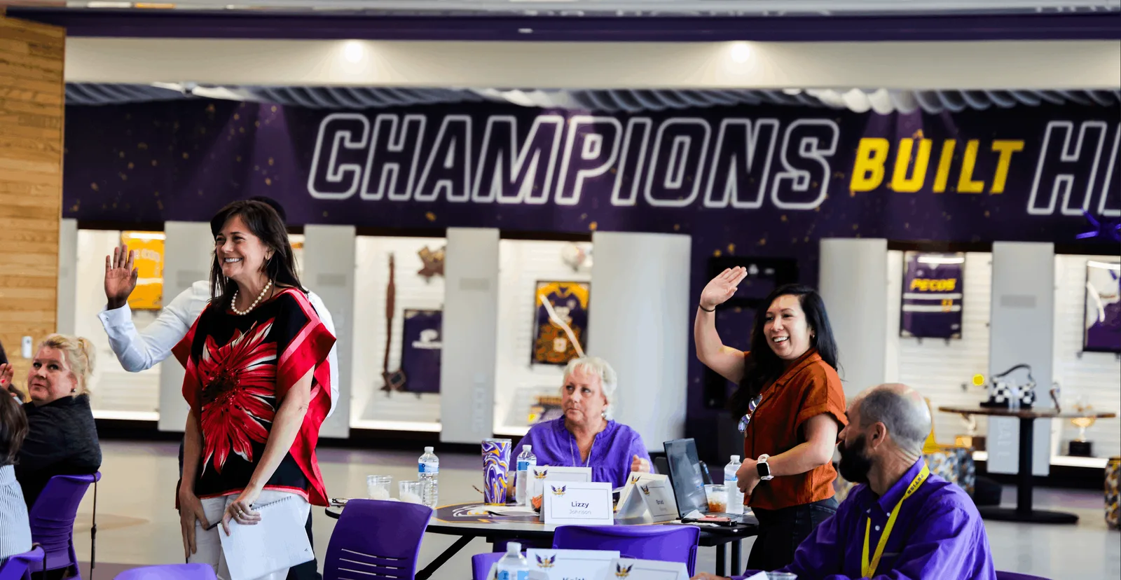 Pecos-Barstow-Toyah ISD teachers waving during a professional development session in the district athletics hall